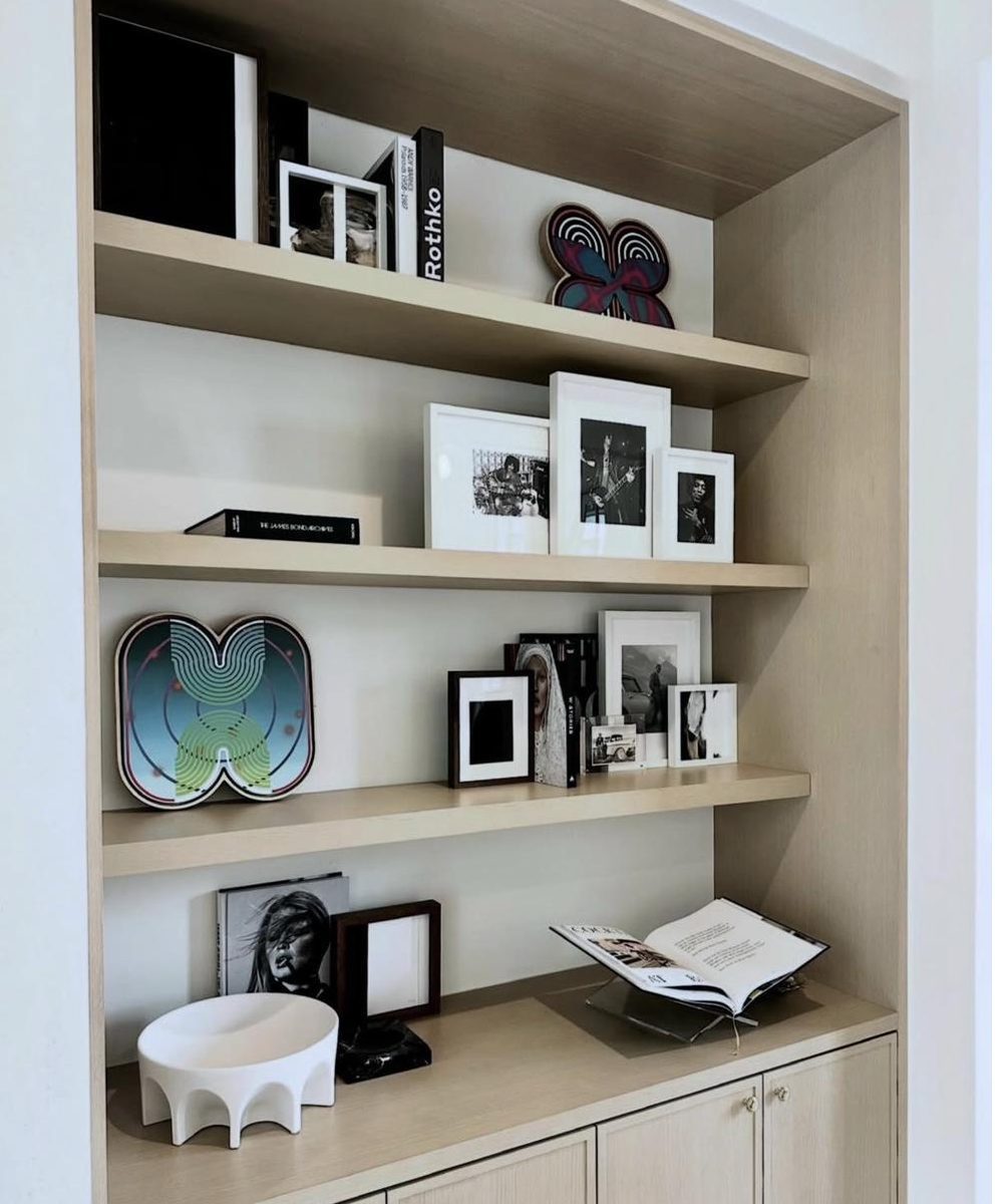 Light oak built-in bookcase with Rothko, framed photos and art objects